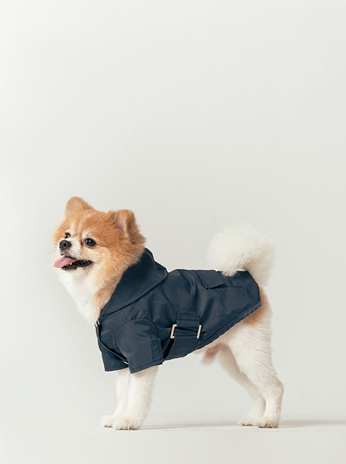 Side profile of blue waterproof dog jacket showing adjustable waist belt with velcro