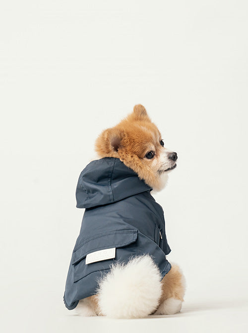 Close up of back pocket detail on blue pet raincoat with white logo