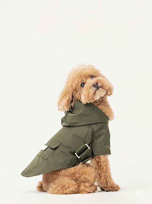 Side profile of green pet raincoat showing hood and adjustable fit