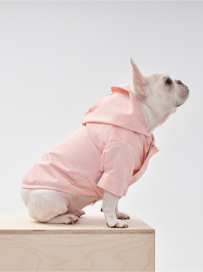 Side profile of light pink waterproof dog coat showing full coverage