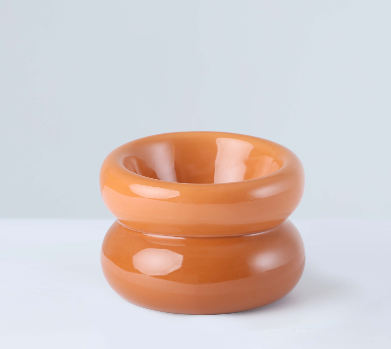 Front view of PEHOM Amber Orange Soufflé Pet Bowl with tilted opening