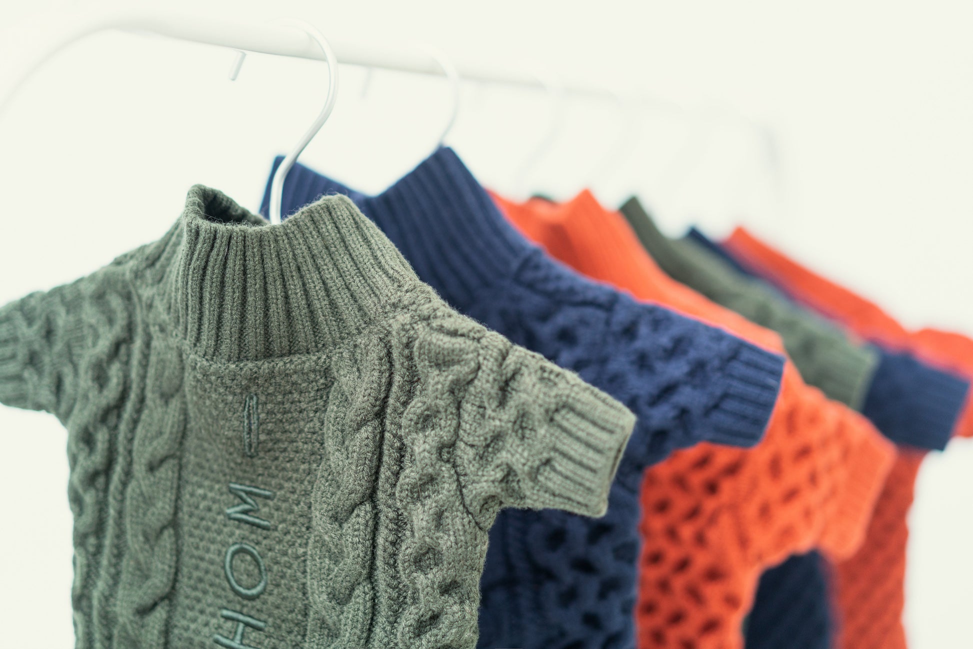 Close up of soft ribbed knit texture and buttons on the blue dog sweater