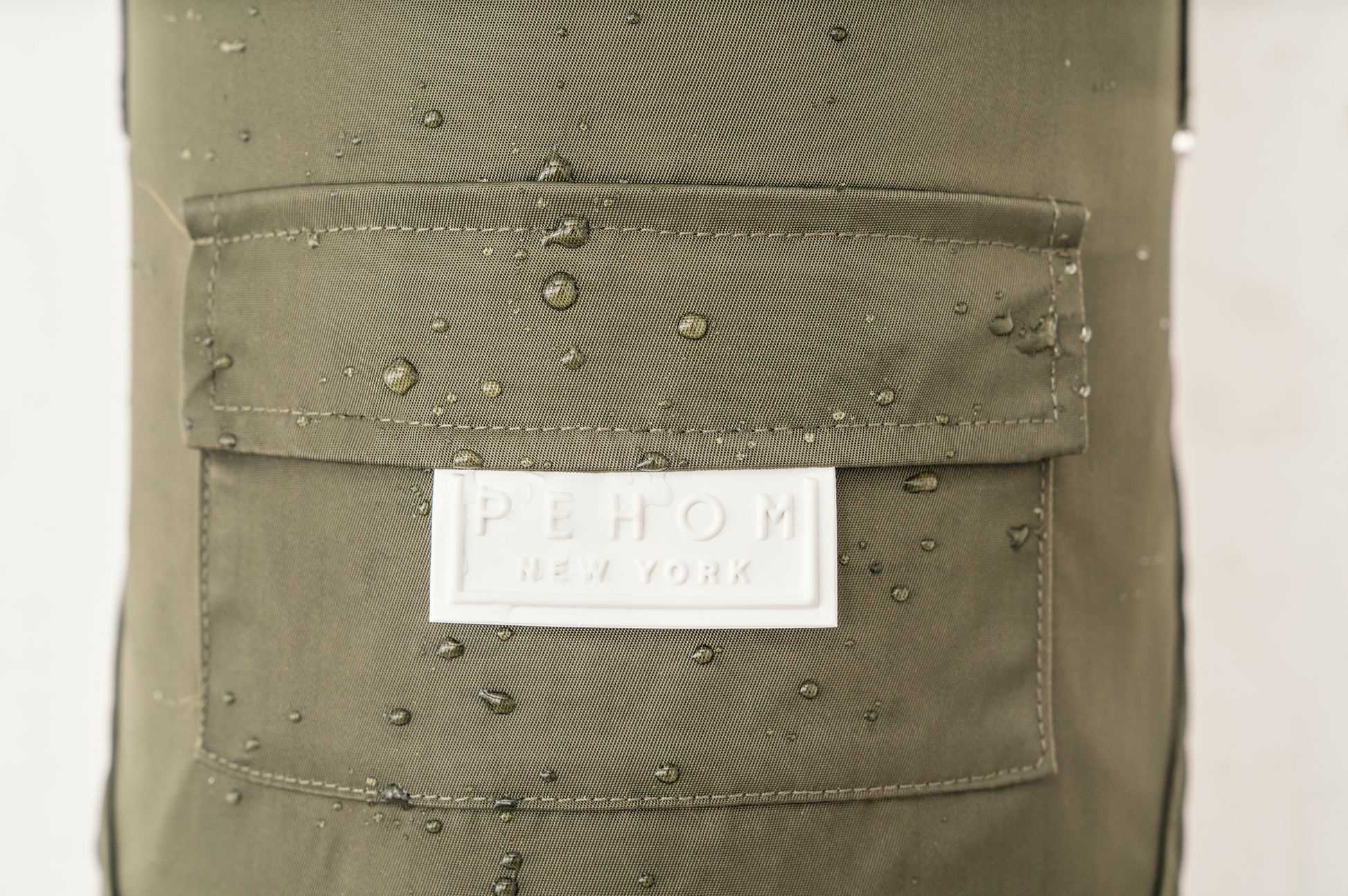Close up of back leash hole and 3M reflective strips on the gray raincoat